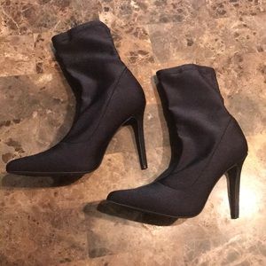 Black pointed toe heeled booties